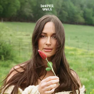 Deeper Well album cover. Kacey Musgraves centered in the frame cut off at the shoulders, holding up a not yet bloomed tulip.